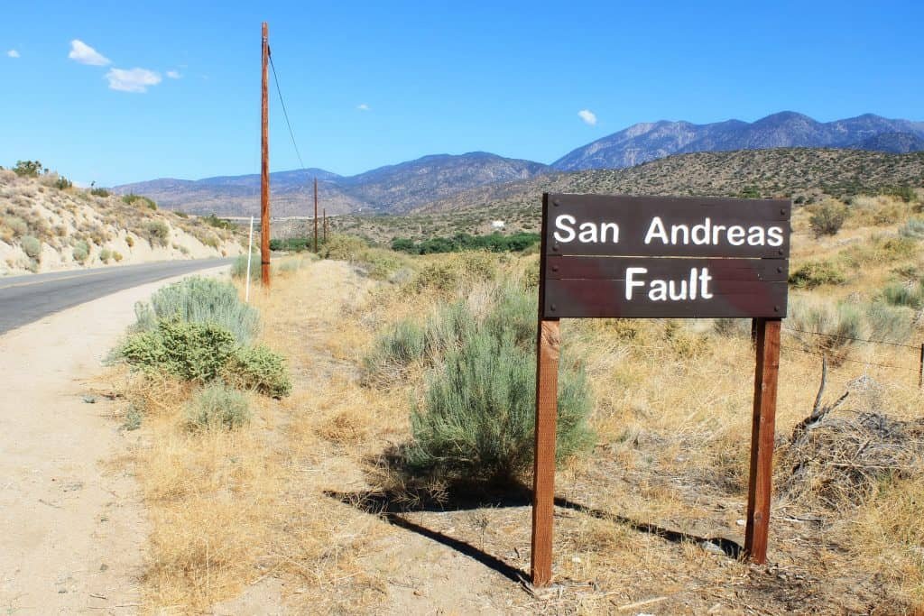The image shows the plaque that indicates the failure of San Andreas, which passes through the south of California. Geological failures are related to the incidence of earthquake