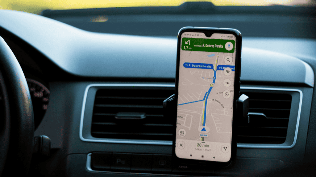 The picture shows a car driver guided by Google Maps GPS