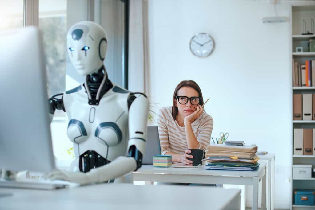 Disappointing stressed woman and a robot and sitting at the office table and working