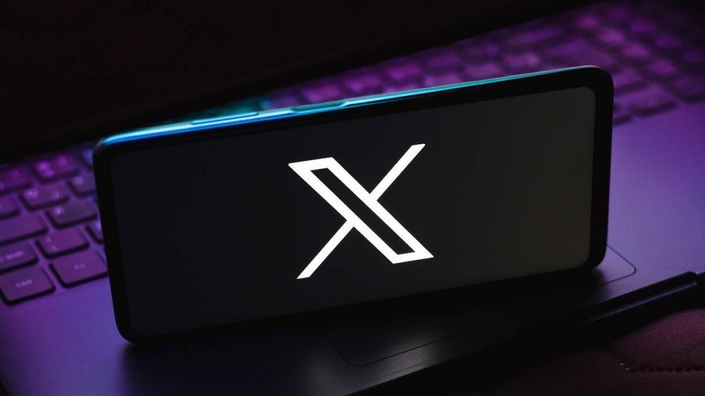 X black background logo on a smartphone